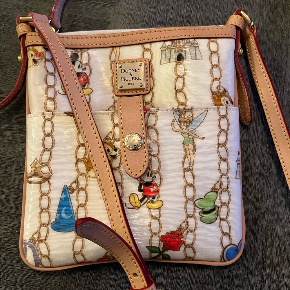 Dooney & Bourke 1975 cross body, Disney series. New w/o tags 8”x 8.5”